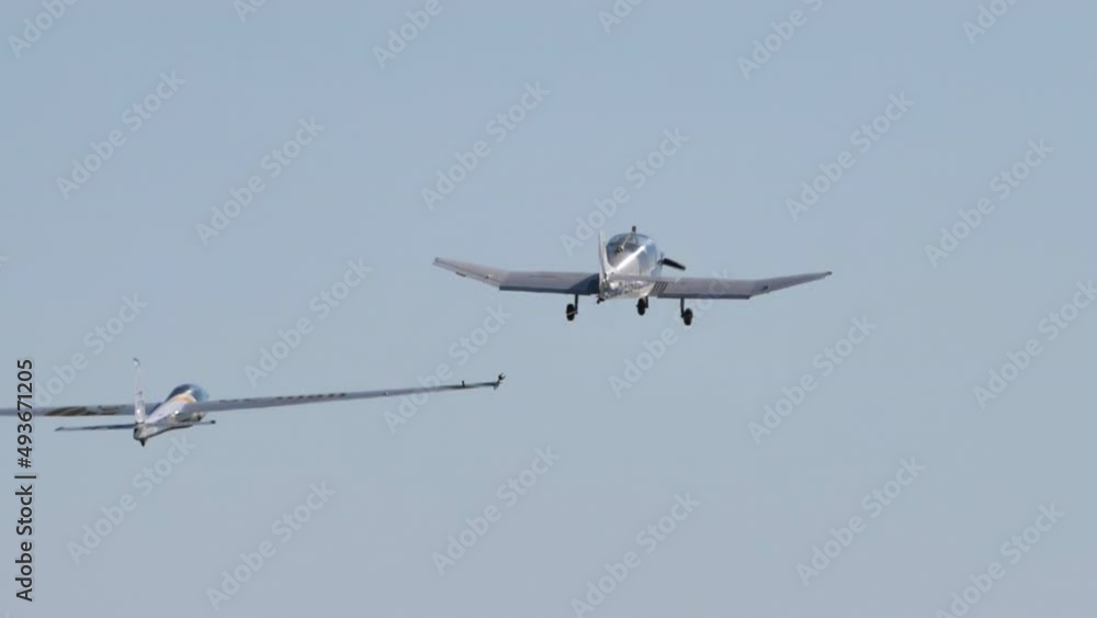 Air show of the Swift S-1 a single seat aerobatic glider performing during a public demonstration with clear blue sky Air show of the Swift S-1 a single seat aerobatic glider performing during a public demonstration with clear blue sky