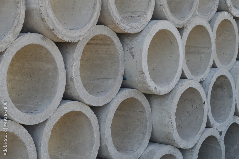 large concrete sewer pipes lined up on the ground large concrete sewer pipes lined up on the ground