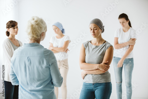 Meeting of group of women talking together during psychotherapy with senior counselor