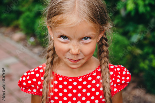Quadro su tela Close-up portrait of funny little girl with pigtails outdoor