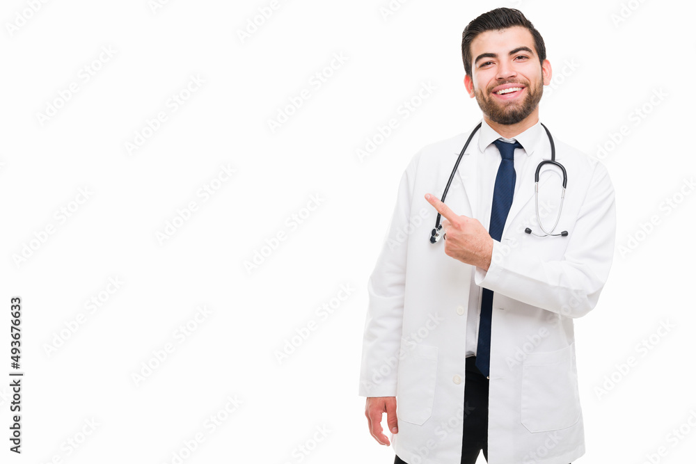 Excited doctor pointing to copyspace