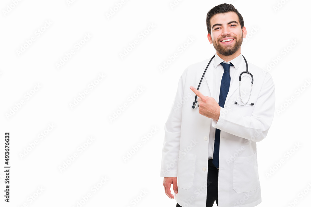 Excited doctor pointing to copyspace Excited doctor pointing to copyspace