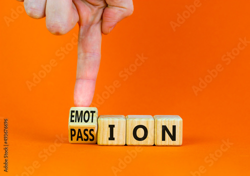 Passion or emotion symbol. Businessman turns a wooden cube and changes the word Emotion to Passion. Beautiful orange table, orange background, copy space. Business, passion or emotion concept.