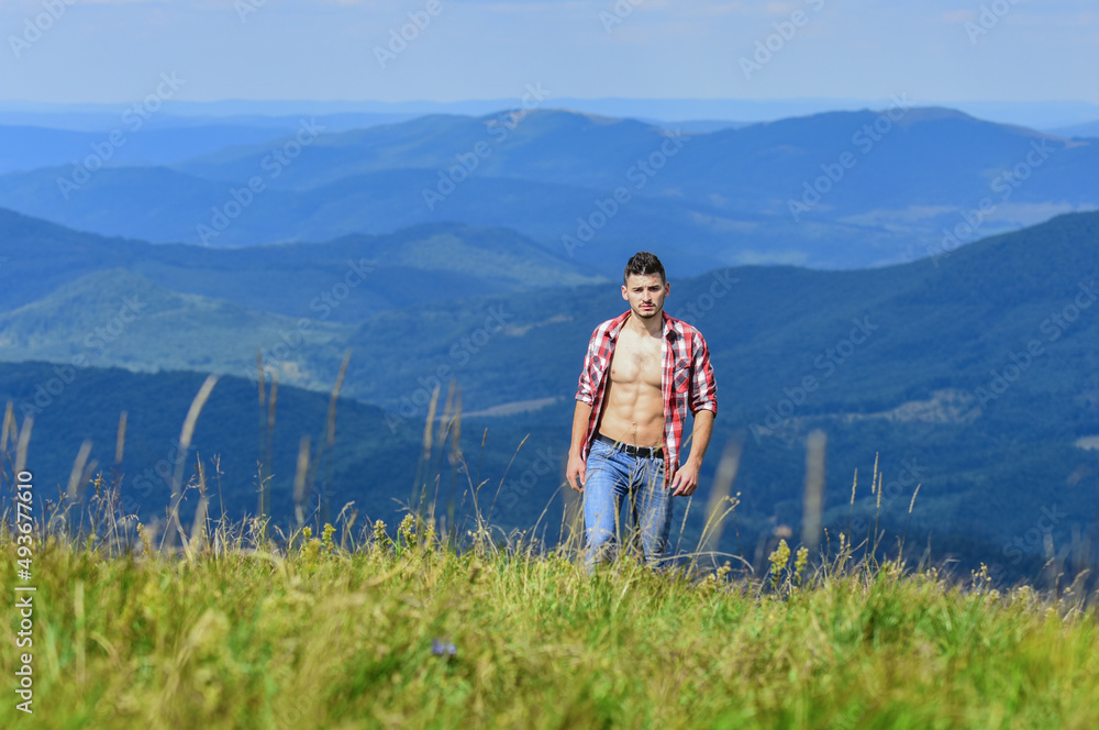 my world. travelling adventure. hipster fashion. countryside concept. farmer on rancho. sexy macho man in checkered shirt. cowboy in hat outdoor. man on mountain landscape. camping and hiking