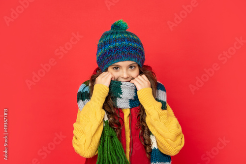 portrait of child wearing warm clothes. express positive emotion. winter fashion.