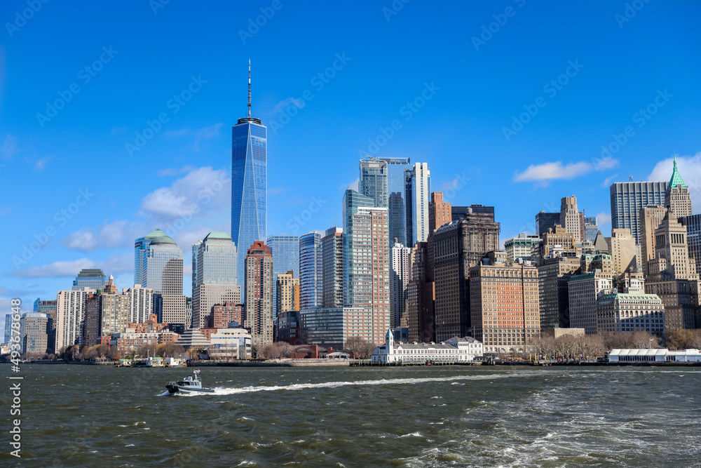 Views of Battery Park and the financial district from the water and Ellis Island in New York City Views of Battery Park and the financial district from the water and Ellis Island in New York City
