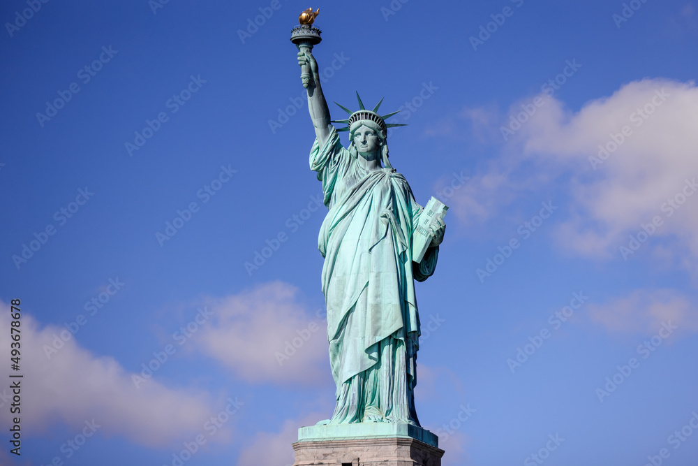 Fototapeta premium The Statue of Liberty in New York against a blue sky