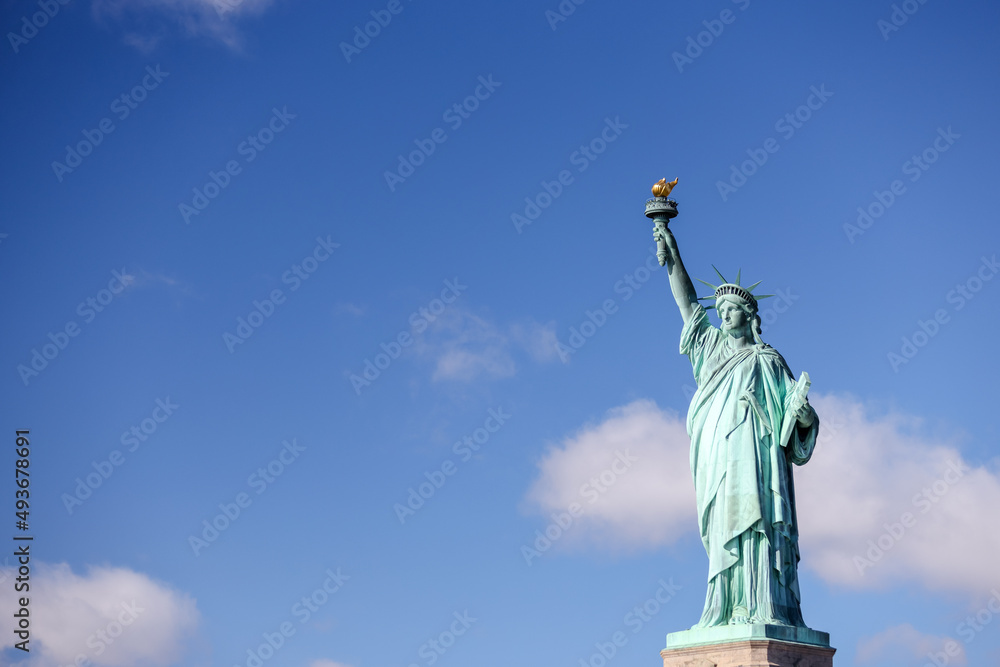 Fototapeta premium The Statue of Liberty in New York against a blue sky