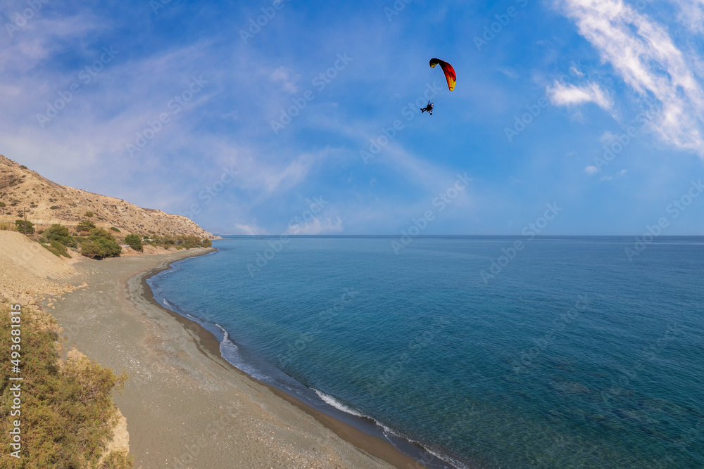 Summer landscape of Crete island in Greece in Europe. Coast in the Larapetra region. In the background is a sunny sky with clouds. Summer landscape of Crete island in Greece in Europe. Coast in the Larapetra region. In the background is a sunny sky with clouds.