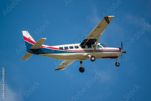 Φωτογραφία Cessna 208b Grand Caravan G-BZAH light aircraft ascending from take off in a cle