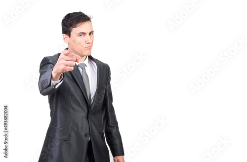 Positive handsome businessman in suit pointing at camera