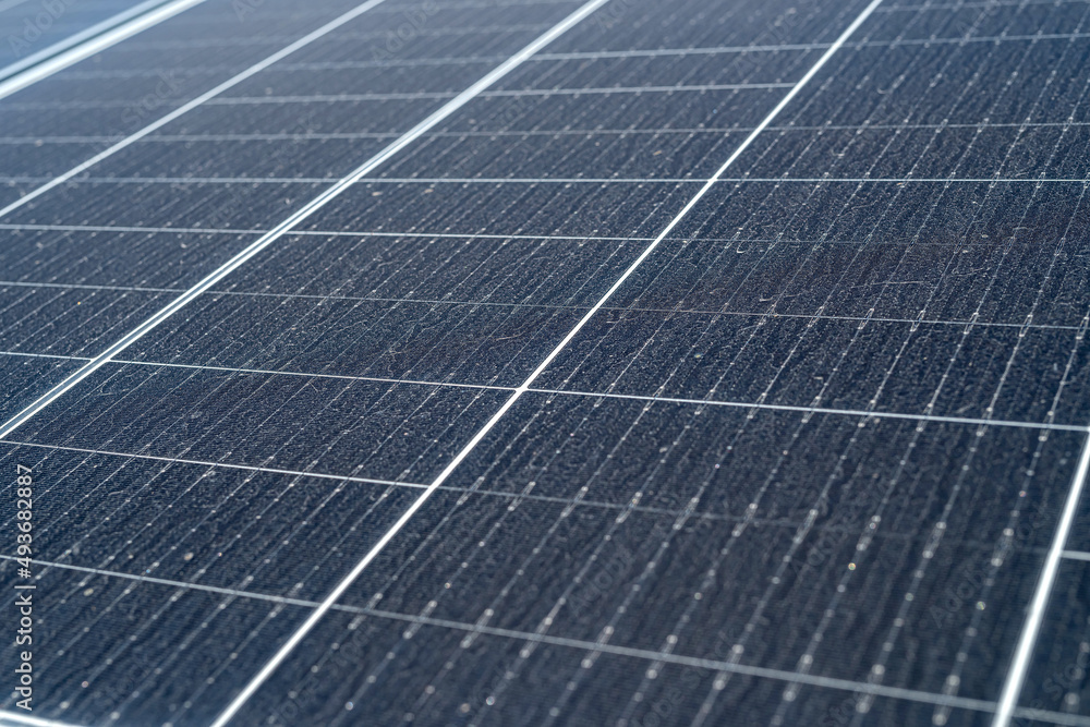 new solar panels are standing on the ground covered with grass new solar panels are standing on the ground covered with grass