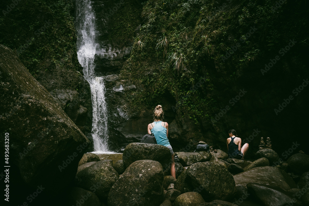 women at a waterfall
