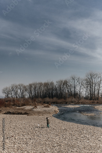 
girl with a dog walking on a background of mountains
nature
river