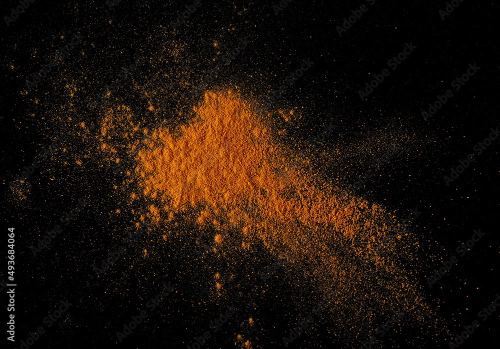 Turmeric powder pile isolated on black, top view Turmeric powder pile isolated on black, top view