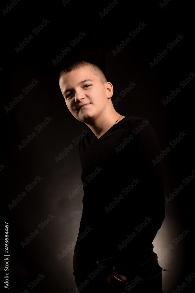 Young guy with a short haircut on a black clipping background