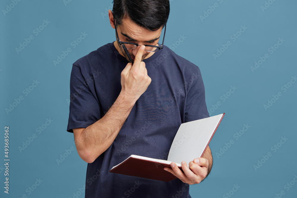 portrait man blue t-shirt with notepad glasses idea pen cropped view portrait man blue t-shirt with notepad glasses idea pen cropped view