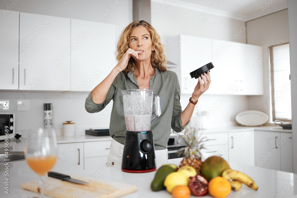 I think this might be my best smoothie yet. Shot of a woman tasting her smoothie before serving it. I think this might be my best smoothie yet. Shot of a woman tasting her smoothie before serving it.