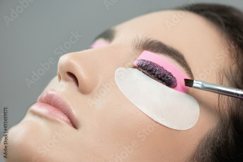Wallpaper Mural Master applies lash dye to eyelashes. Close-up of beauty model's face during lash lift laminating botox procedure. Eyelash Care Treatment: eyelash lifting and curling, lash lamination and extension Torontodigital.ca