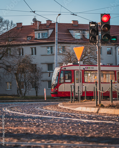 A tram going through the streets of Nowy Port in Gdańsk on a sunny morning.