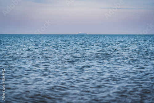A calm sea surface on a cloudy day.