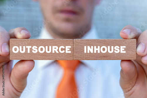 Concept of outsource or inhouse choice. Outsource or insource making decision. Outsourcing Global Recruitment. Human Resources. photo