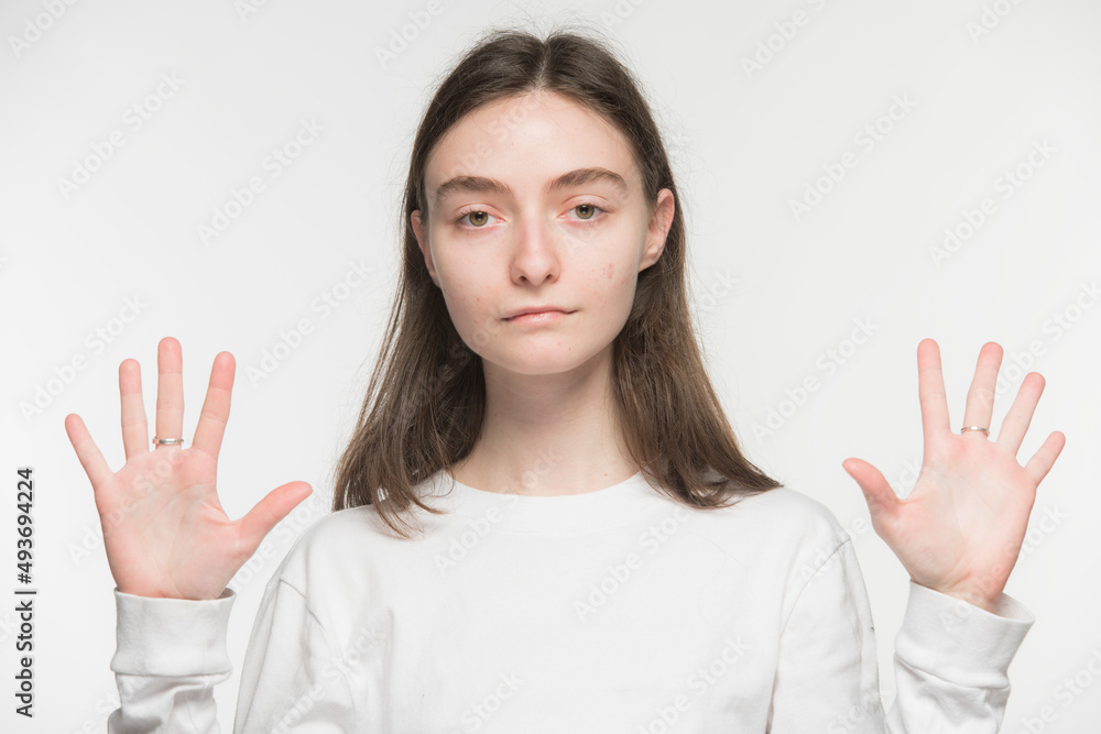close-up portrait of a young Ukrainian girl who shows the number with her hands on a white background
close-up portrait of a young Ukrainian girl who shows the number with her hands on a white background