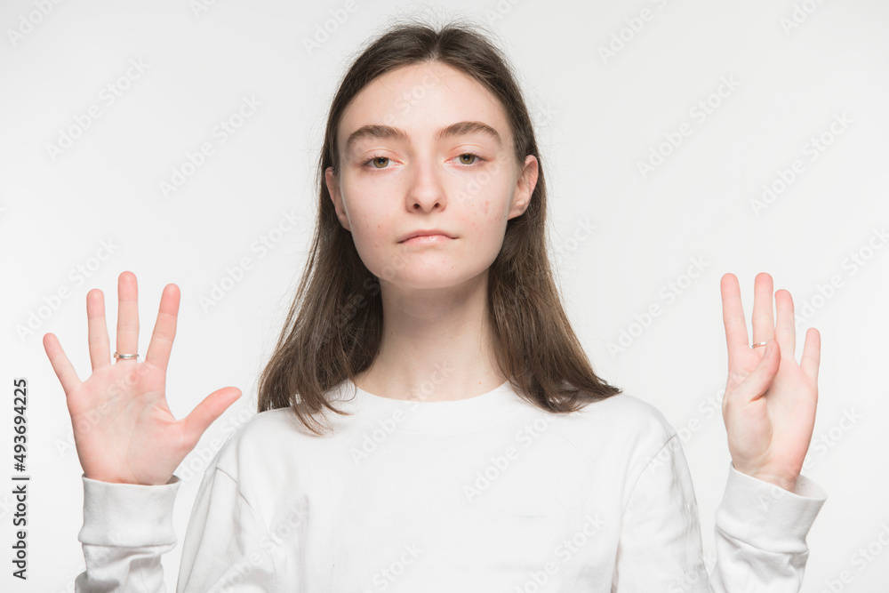 close-up portrait of a young Ukrainian girl who shows the number with her hands on a white background
close-up portrait of a young Ukrainian girl who shows the number with her hands on a white background