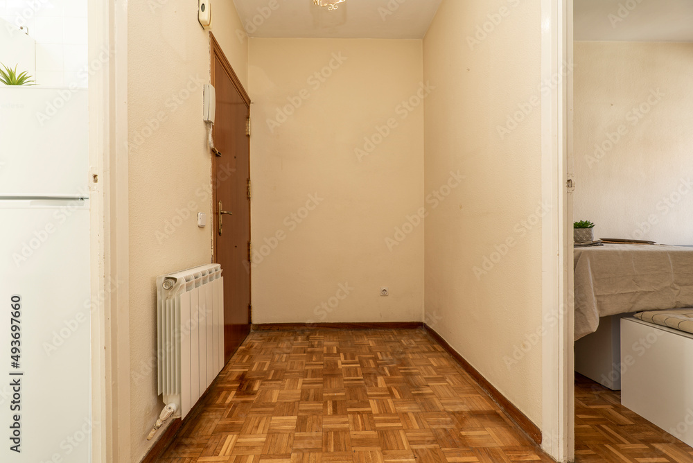Distributor corridor of a residential house with entrance to a furnished living room and oak parquet floors Distributor corridor of a residential house with entrance to a furnished living room and oak parquet floors