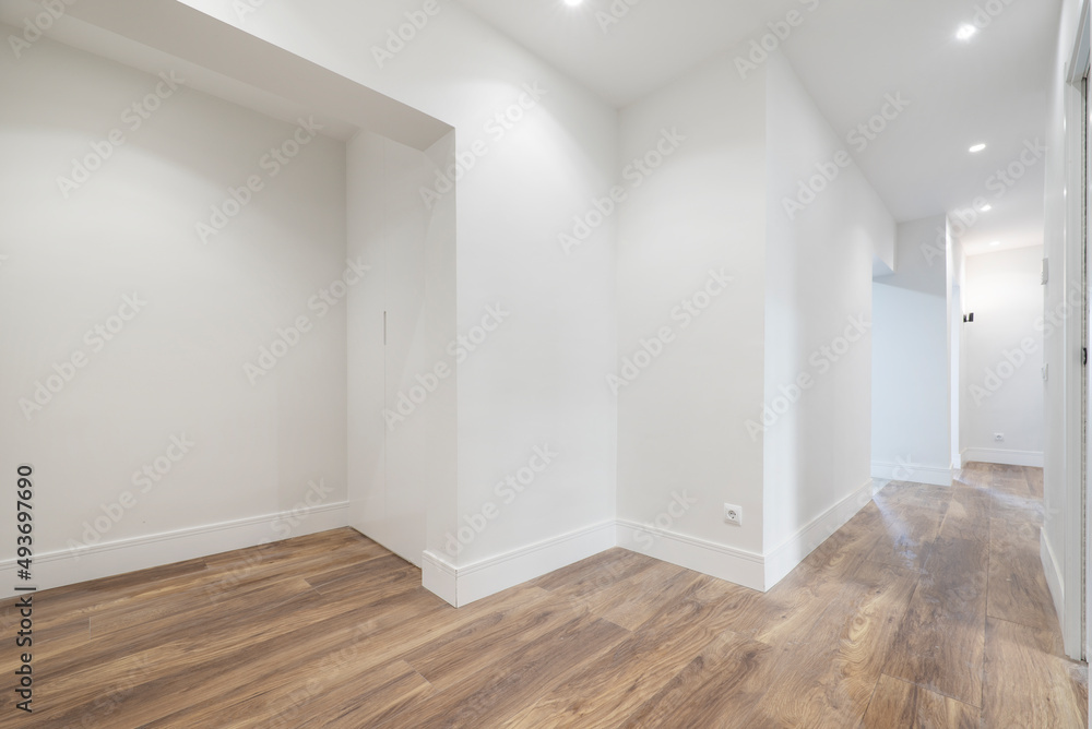 Entrance hall of a recently renovated house with wooden floors and fitted wardrobes Entrance hall of a recently renovated house with wooden floors and fitted wardrobes