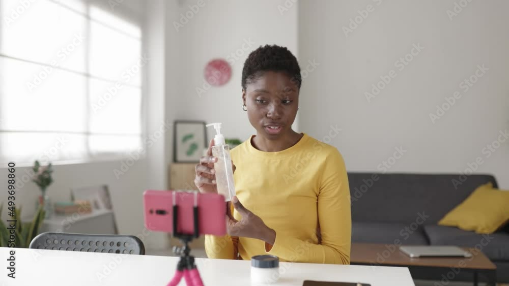 Young african influencer woman streaming online about cosmetic product for skin - Female blogger having fun while vlogging about beauty on social media network - High quality 4k footage Young african influencer woman streaming online about cosmetic product for skin - Female blogger having fun while vlogging about beauty on social media network - High quality 4k footage