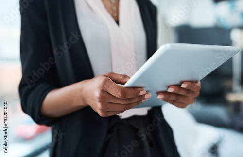 Technology is the way of the future. Closeup shot of an unrecognizable businesswoman using a tablet in an office.