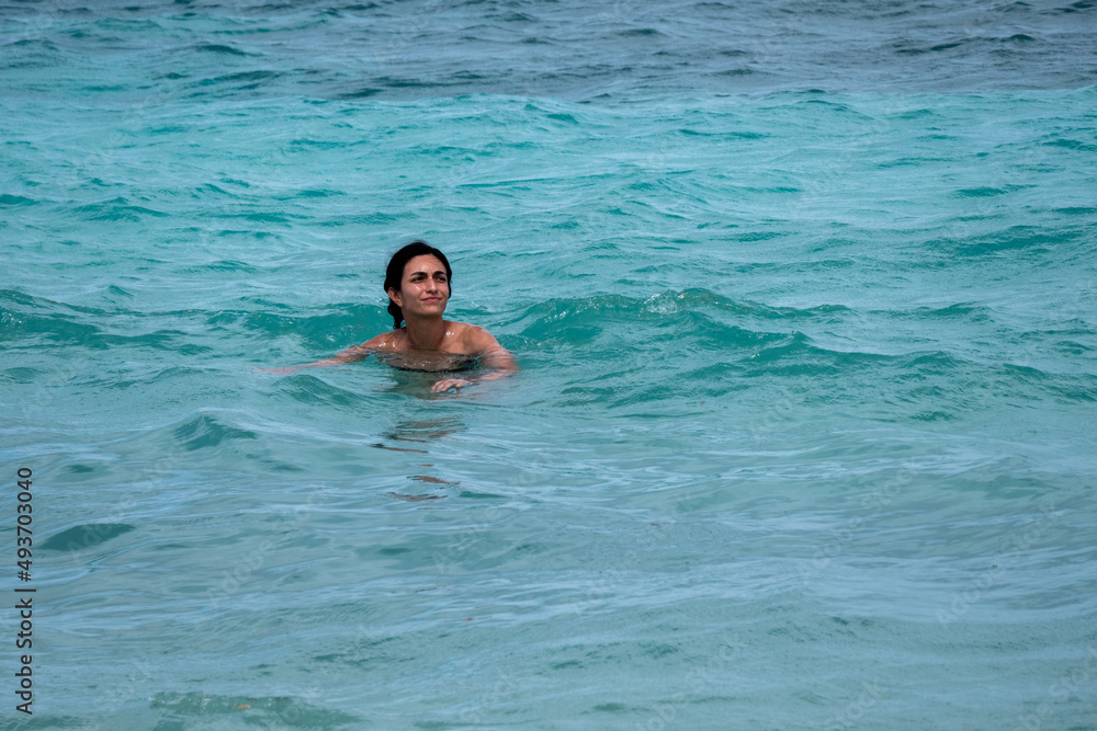 Black-Haired Woman Swimming in the Caribbean Sea in San Andres, Colombia