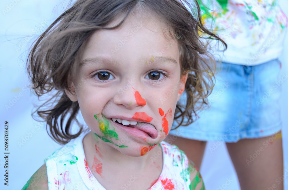 Child in foreground, with painting of having played with it, portrait. Child in foreground, with painting of having played with it, portrait.