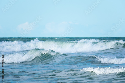 Crashing ocean waves horizon with a blue sky  Blue background  Ocean scene
