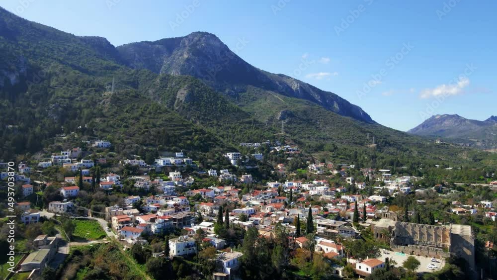 Aerial 4K view of beautiful Bellapais Village with Bellapais Monastery in Kyrenia, North Cyprus surrounded with an amazing green Mediterranean nature and picturesque landscapes in Cyprus. Aerial 4K view of beautiful Bellapais Village with Bellapais Monastery in Kyrenia, North Cyprus surrounded with an amazing green Mediterranean nature and picturesque landscapes in Cyprus.