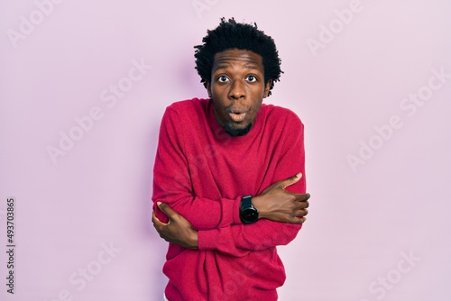 Young african american man wearing casual clothes shaking and freezing for winter cold with sad and shock expression on face
