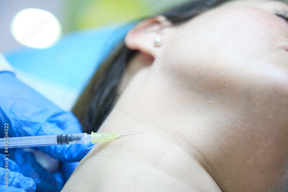applying mesotherapy on the neck of a patient