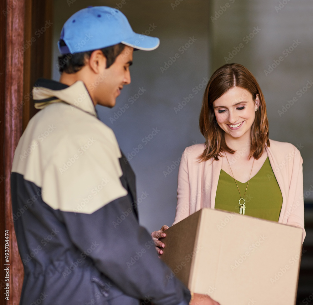 Making another customer 100 satisfied. Cropped shot of a courier making a delivery to a customer at her home. Making another customer 100 satisfied. Cropped shot of a courier making a delivery to a customer at her home.