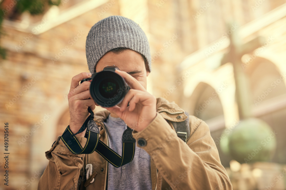 Ive found the perfect shot. Portrait of a young man taking photos on his camera outside. Ive found the perfect shot. Portrait of a young man taking photos on his camera outside.