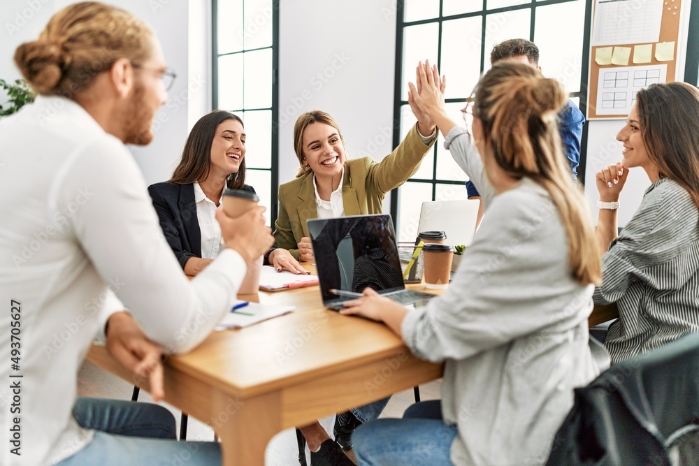 Two workers smiling happy high five during meeting at the office. Two workers smiling happy high five during meeting at the office.