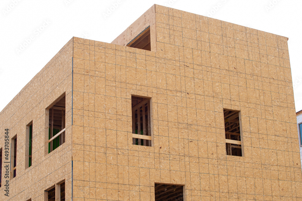 Construction of a new apartment building with the walls framed and covered with plywood modern Construction of a new apartment building with the walls framed and covered with plywood modern