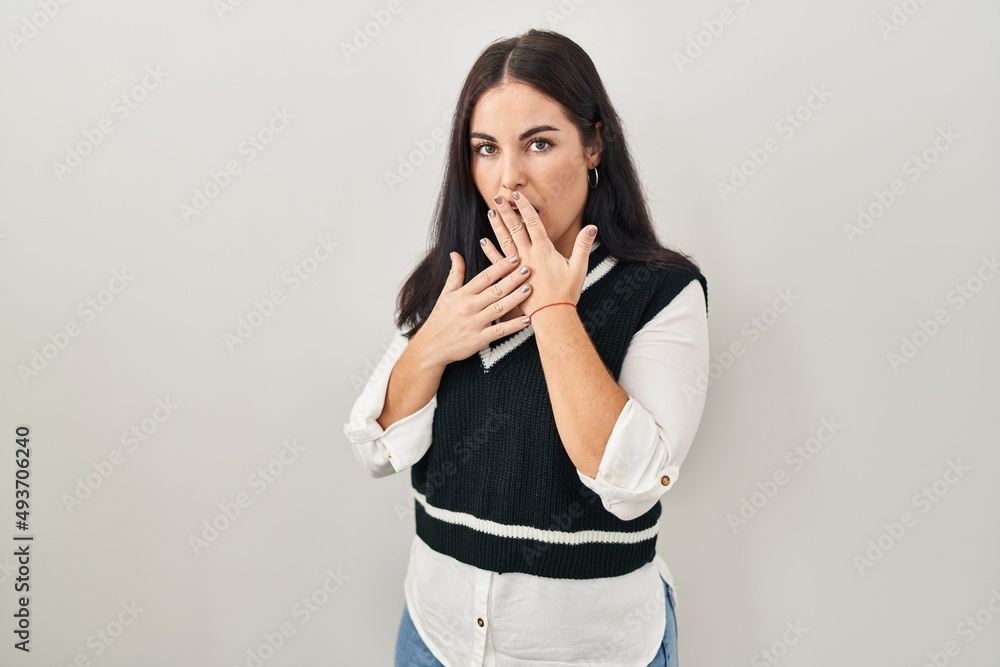 Young hispanic woman standing over isolated background bored yawning tired covering mouth with hand. restless and sleepiness. Young hispanic woman standing over isolated background bored yawning tired covering mouth with hand. restless and sleepiness.