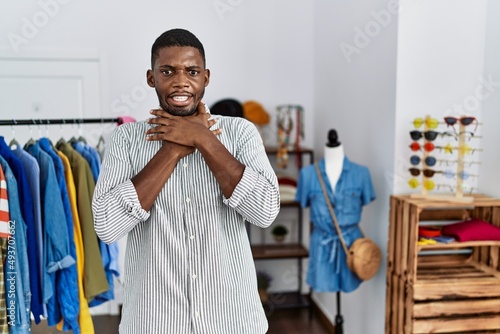 Young african american man working as manager at retail boutique shouting and suffocate because painful strangle. health problem. asphyxiate and suicide concept.