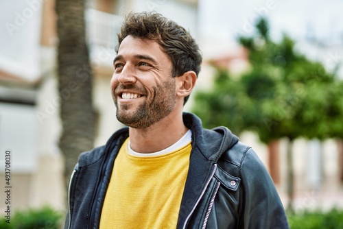 Handsome hispanic man with beard smiling happy outdoors © Krakenimages.com