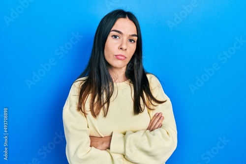 Young brunette woman wearing casual sweatshirt skeptic and nervous, disapproving expression on face with crossed arms. negative person. © Krakenimages.com