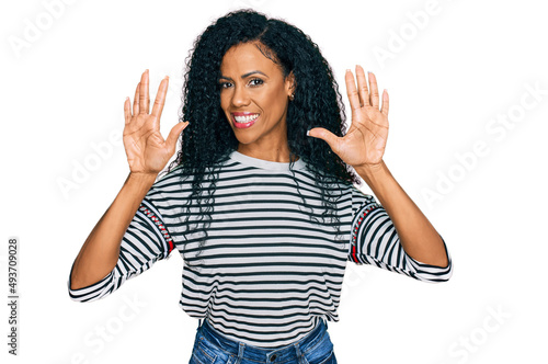 Middle age african american woman wearing casual clothes showing and pointing up with fingers number ten while smiling confident and happy.
