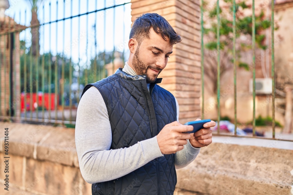 Young hispanic man smiling confident using smartphone at street Young hispanic man smiling confident using smartphone at street