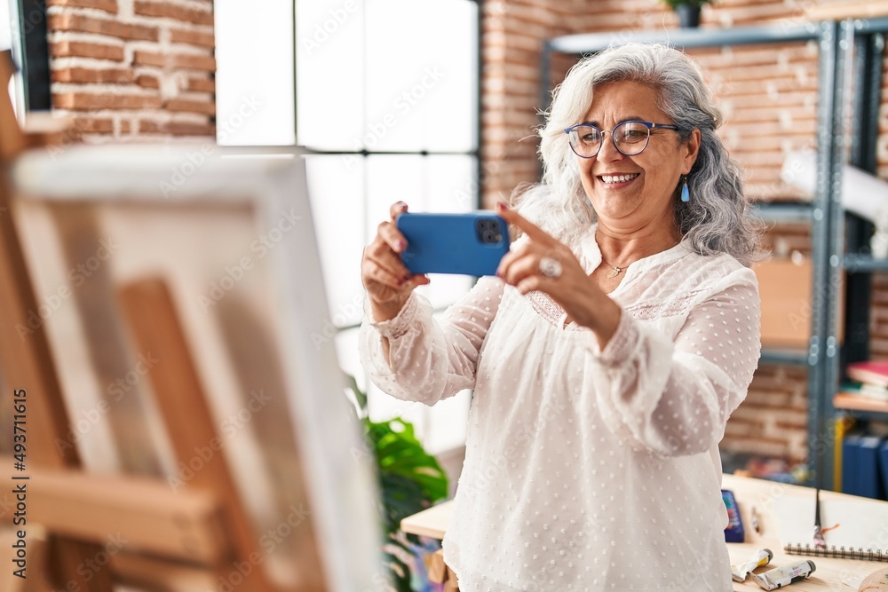 Middle age woman artist make photo by smartphone to draw at art studio Middle age woman artist make photo by smartphone to draw at art studio