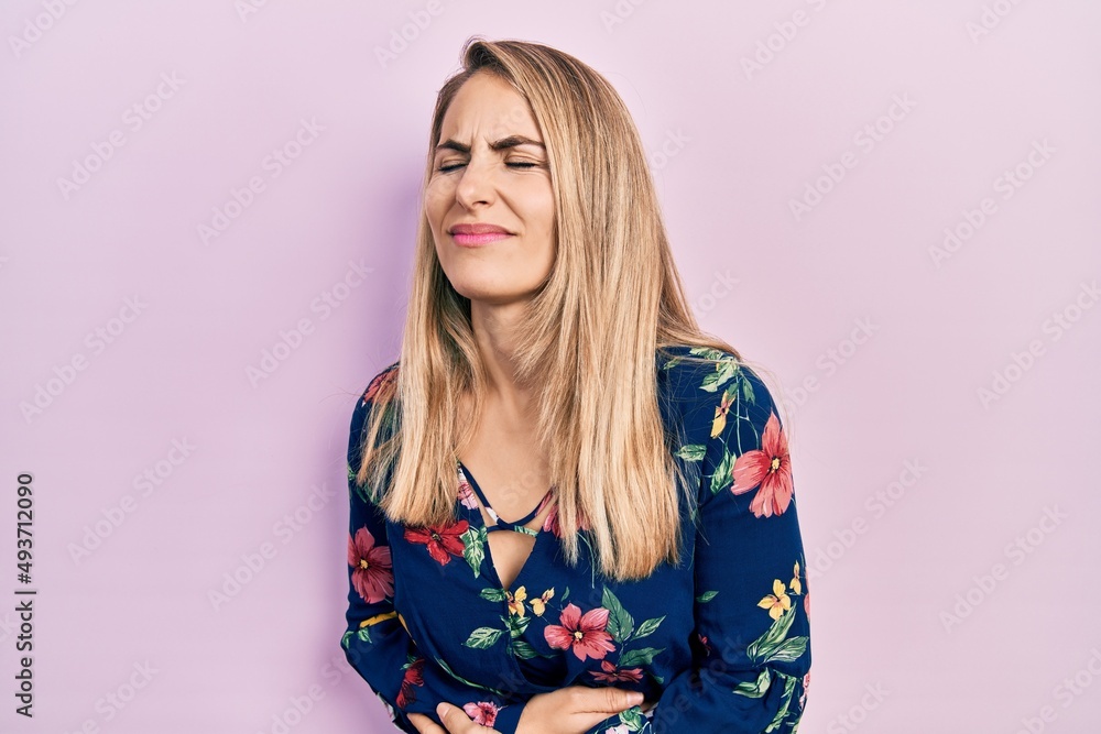 Young caucasian woman wearing casual clothes with hand on stomach because indigestion, painful illness feeling unwell. ache concept. Young caucasian woman wearing casual clothes with hand on stomach because indigestion, painful illness feeling unwell. ache concept.